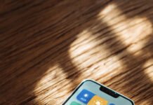 Best Free Health & Wellness Apps for Beginners: Sleep, Water, Steps & Calm Smartphone on a table showing colorful health and wellness app icons for steps, water, sleep, and calm