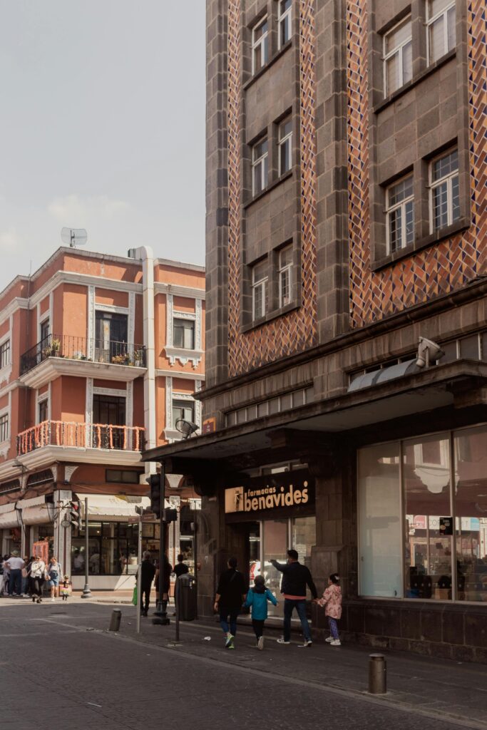 Colorful street in Mexico City with historic buildings and people walking