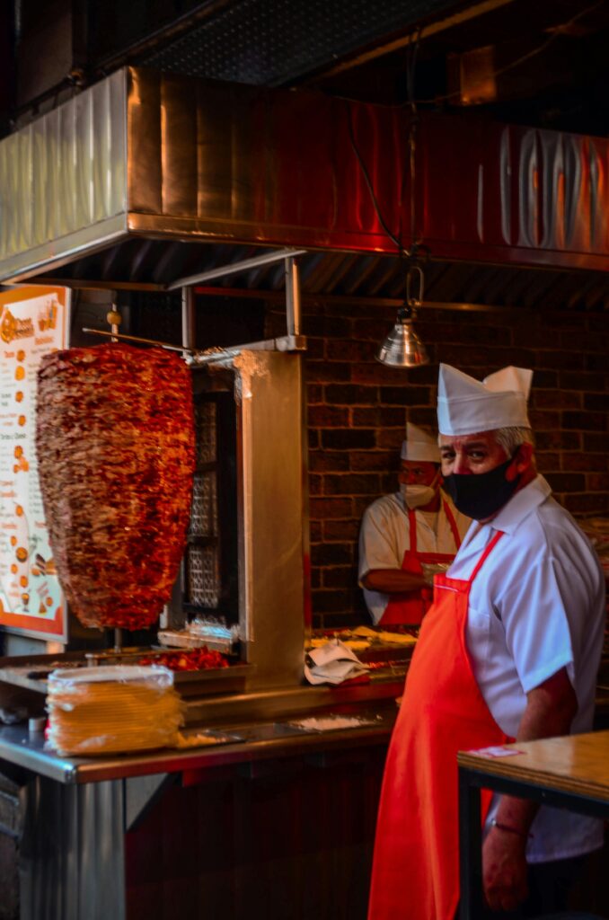 Street food stall in a Muslim-majority country serving grilled meat and snacks
