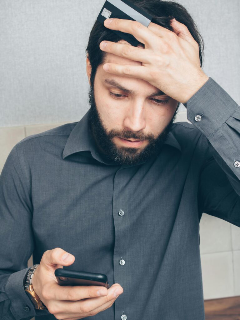  Person looking upset at a broken smartphone symbolizing lost photos and data