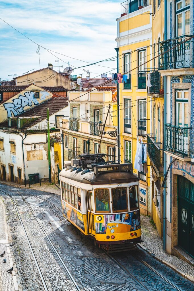 Colorful street with a yellow tram in Lisbon, Portugal on a sunny day